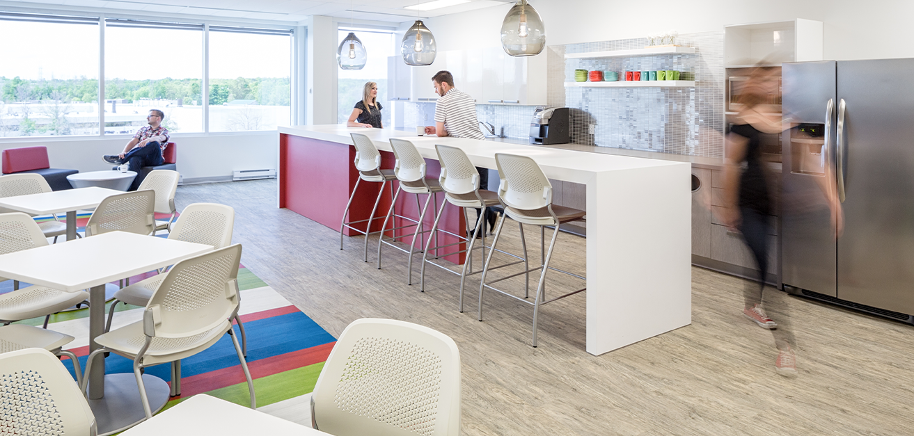 Open concept cafeteria/office kitchen with people walking by